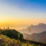 photo-of-people-standing-on-top-of-mountain-near-grasses-733162.jpg